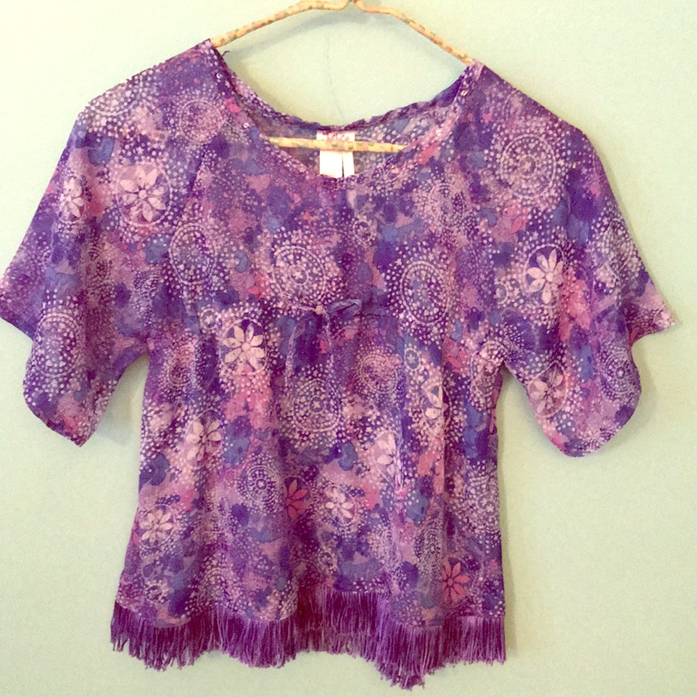 Sheer top with fringed bottom and sparkle thread.